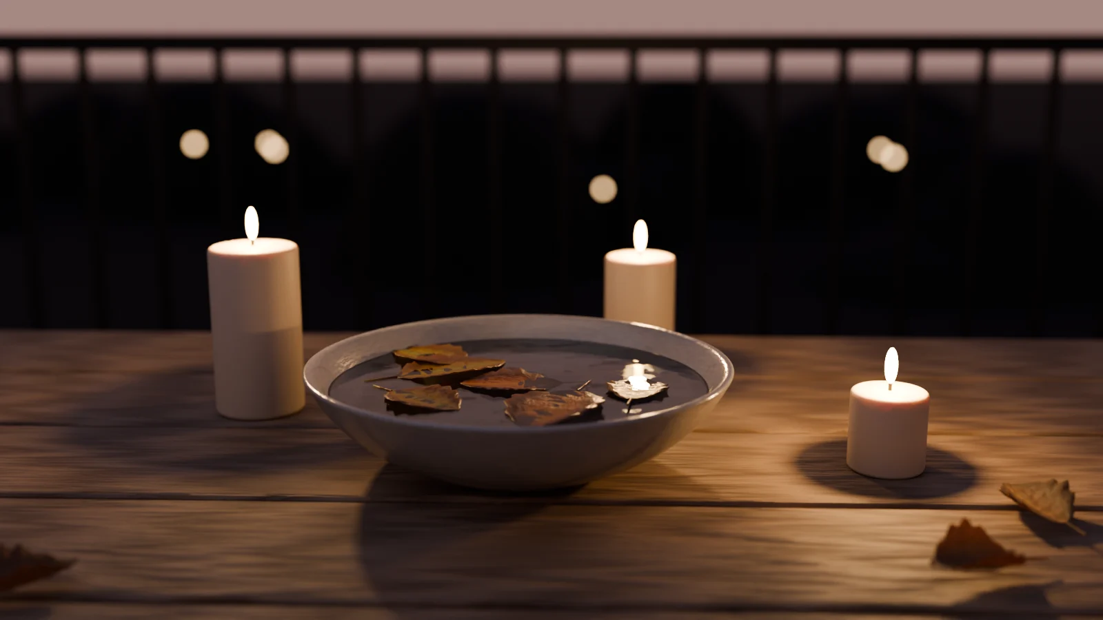 A shallow stoneware bowl of water with brown leaves floating in it, surrounded by lit candles on a wooden balcony table at dusk.